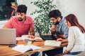 Multi ethnic young students preparing for exams in home interior Royalty Free Stock Photo