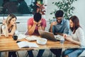 Group of young students preparing for exams in home interior Royalty Free Stock Photo