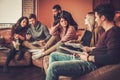 Group of multi ethnic young students preparing for exams in home interior Royalty Free Stock Photo