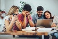 Group of young students preparing for exams in home interior Royalty Free Stock Photo