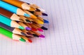 Group of multicolor pencils on white checkbook