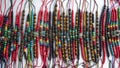 Group of multicolored bracelets made by hand by indigenous Ecuadorians for sale in a craft market