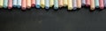 Group of multicolored chalks on black chalkboard Royalty Free Stock Photo