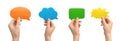 Group of multicolored speech bubbles in hands, empty cardboard and paper mockup banner, giving feedback concept Royalty Free Stock Photo