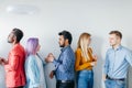 Multiethnic Group of Young People in Casual Wear over grey background