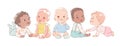 A group of multicultural cute little baby boys and baby girls in sitting on a white