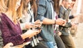 Group of multicultural friends using smartphone at university co Royalty Free Stock Photo