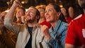 Group of Multicultural Friends Watching a Live Soccer Match in a Sports Bar. Focus on Beautiful Royalty Free Stock Photo