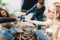 group of multicultural teens clinking