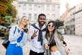 Group of multicultural tourists friends having fun taking selfie on the background of old European town buildings Royalty Free Stock Photo