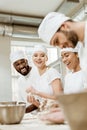 group of multiethnic baking manufacture workers kneading