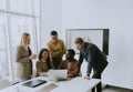 Group of multiethnic business people working together and preparing new project on a meeting in office Royalty Free Stock Photo