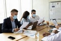 Group Of Multiethnic Colleagues Wearing Protective Face Masks Working Together In Office Royalty Free Stock Photo