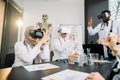 Group of multiethnic doctors scientists, African and Caucasian men, Muslim woman, wearing vr glasses working with 3d