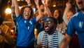 Group of Multiethnic Friends Watching a Live Soccer Match on TV in a Sports Bar. Fans with Painted