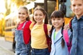 Group Of Multiethnic Happy Kids Standing Outdoors Near School Bus Royalty Free Stock Photo