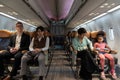 Multiethnic passengers sitting in airplane cabin during flight Royalty Free Stock Photo