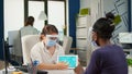 Group of multiethnic people with face masks analyzing financial data