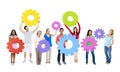 Group of Multiethnic People Holding Colorful Cogs