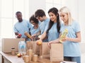 Volunteers packing food and drinks into paper bags