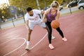 Group of multiethnic people  playing basketball on court Royalty Free Stock Photo