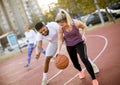 Group of multiethnic people  playing basketball on court Royalty Free Stock Photo