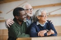 Senior friends embracing and looking away Royalty Free Stock Photo