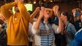 Group of Multiethnic Soccer Fans Watching a Live Football Match in a Sports Bar. People Standing in Royalty Free Stock Photo