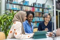 Group of multiethnic students in a library Royalty Free Stock Photo