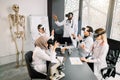 Group of multiethnic students with professor learn medicine or scientific project with vr glasses in modern laboratory