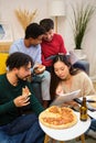 Group of multiethnic university colleagues studying and eating pizza together. Royalty Free Stock Photo