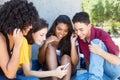 Group of multiethnic young adult playing game with mobile app