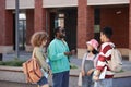 Group of multiethnic young students chatting happily outdoors Royalty Free Stock Photo