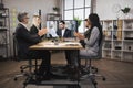 Group of multiethnical businesspeople clapping hands and looking at screen, having video conference Royalty Free Stock Photo