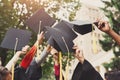 A group of graduates throwing graduation caps in the air Royalty Free Stock Photo