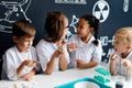 Group of multiracial diverse kids carrying out a science experiment in lab Royalty Free Stock Photo