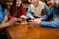 Group of multiracial friends enjoying in cafe together. Young people meeting in a cafe. Young men and women sitting at Royalty Free Stock Photo