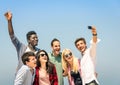 Group of multiracial friends taking a selfie on a blue sky Royalty Free Stock Photo