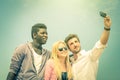 Group of multiracial happy best friends taking a vintage selfie