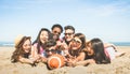 Group of multiracial happy friends having fun playing sport beach games - International concept of summer joy and multicultural f Royalty Free Stock Photo