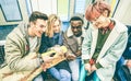 Group of multiracial hipster friends having fun in subway train Royalty Free Stock Photo