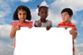 Group of multiracial kids portrait with white board. Royalty Free Stock Photo