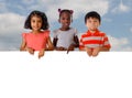 Group of multiracial kids portrait with white board Royalty Free Stock Photo