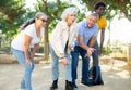 A group of multiracial mature adult people playing patanque game outdoors in a park Royalty Free Stock Photo