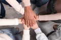 Group of multiracial people joining hands together indoors, top view Royalty Free Stock Photo