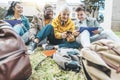 Group of multiracial students having fun sitting in college campus together - Happy teenagers using smart mobile phone outside Royalty Free Stock Photo