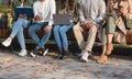 Group of students sitting on bench in park and studying Royalty Free Stock Photo