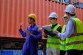 Group of workers teamwork at logistics terminal with many stacks of containers Royalty Free Stock Photo