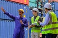 Group of workers teamwork at logistics terminal with many stacks of containers Royalty Free Stock Photo