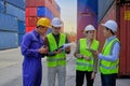 Group of workers teamwork at logistics terminal with many stacks of containers Royalty Free Stock Photo